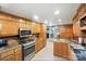 Spacious kitchen featuring stainless steel appliances, custom cabinets, granite countertops and hardwood floors at 4412 Dobys Bridge Rd, Fort Mill, SC 29707