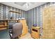 Home office with decorative wallpaper, a desk, and storage cabinets; an ideal workspace at 4412 Dobys Bridge Rd, Fort Mill, SC 29707