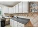Pantry features white cabinets, grey counters, and a sink; providing ample storage and functionality at 4412 Dobys Bridge Rd, Fort Mill, SC 29707