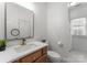 Bathroom features marble countertop vanity, gold faucet, toilet, and shower with white tiling at 4536 Rustling Woods Dr, Denver, NC 28037