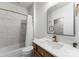 Elegant bathroom featuring white marble, a glass shower door, and wood vanity, combining luxury and functionality at 4536 Rustling Woods Dr, Denver, NC 28037
