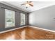 This room features hardwood floors, neutral paint, and large windows with plantation shutters at 4536 Rustling Woods Dr, Denver, NC 28037