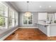 Bright dining area featuring hardwood floors, plantation shutters, and a modern pendant light at 4536 Rustling Woods Dr, Denver, NC 28037