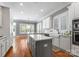 Bright kitchen with white cabinets, stainless steel appliances, an island and farmhouse sink at 4536 Rustling Woods Dr, Denver, NC 28037