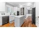 Modern kitchen featuring white cabinets, stainless steel appliances, and a central island at 4536 Rustling Woods Dr, Denver, NC 28037