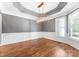 Living room features hardwood floors, modern chandelier, crown molding, and wainscoting at 4536 Rustling Woods Dr, Denver, NC 28037