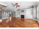 Spacious living room with hardwood floors, fireplace, built-in shelving and staircase at 4536 Rustling Woods Dr, Denver, NC 28037