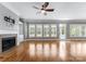 Bright living room featuring hardwood floors, plantation shutters, built-ins, and fireplace at 4536 Rustling Woods Dr, Denver, NC 28037