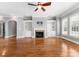 Open living room features hardwood floors, fireplace, built-ins and plantation shutters at 4536 Rustling Woods Dr, Denver, NC 28037