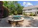 Backyard features a pool with brick patio, surrounded by lush green trees and shrubbery at 4536 Rustling Woods Dr, Denver, NC 28037