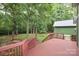 Inviting back deck overlooks a serene backyard surrounded by lush trees, perfect for outdoor relaxation and enjoyment at 458 Leaf Arbor Ct, Clover, SC 29710