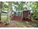 View of the green house with large wooden deck with stairs and covered patio at 458 Leaf Arbor Ct, Clover, SC 29710