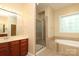 Bright bathroom featuring double vanity, tiled shower, and soaking tub at 458 Leaf Arbor Ct, Clover, SC 29710