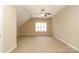 Bonus room with angled ceiling, ceiling fan, and window at 458 Leaf Arbor Ct, Clover, SC 29710