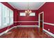 Elegant dining room featuring hardwood floors, wainscoting, and a stylish chandelier at 458 Leaf Arbor Ct, Clover, SC 29710