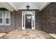 Elegant front door with stone surround and a decorative transom window at 458 Leaf Arbor Ct, Clover, SC 29710
