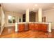 Open kitchen with granite countertops, custom cabinets, stainless steel appliances, and hardwood floors at 458 Leaf Arbor Ct, Clover, SC 29710