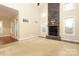Inviting living room boasts a floor-to-ceiling stone fireplace, lots of natural light, and plush carpeting at 458 Leaf Arbor Ct, Clover, SC 29710