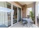 Relaxing balcony with comfortable seating, greenery, and pleasant views of the building exteriors and sky at 4625 Piedmont Row Dr # 712, Charlotte, NC 28210