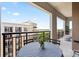 Inviting balcony with comfortable chairs, greenery, and picturesque views of the neighborhood and sky at 4625 Piedmont Row Dr # 712, Charlotte, NC 28210