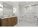 Bright bathroom with a wood vanity, framed mirror, and a shower/bathtub combination at 4625 Piedmont Row Dr # 712, Charlotte, NC 28210