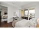 Bedroom with a desk, hardwood floors, a bed, and glass doors leading to a balcony at 4625 Piedmont Row Dr # 712, Charlotte, NC 28210