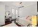 Bright bedroom featuring hardwood floors, a modern chandelier, and a round mirror over a sleek desk at 4625 Piedmont Row Dr # 712, Charlotte, NC 28210