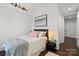 Cozy bedroom with modern light fixture, art on the wall, and an inviting bed with plush pillows at 4625 Piedmont Row Dr # 712, Charlotte, NC 28210