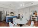 Eat-in kitchen featuring an island, stainless steel appliances, and sleek white cabinetry at 4625 Piedmont Row Dr # 712, Charlotte, NC 28210