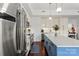 Bright kitchen featuring a stainless steel refrigerator and a large island with a white countertop at 4625 Piedmont Row Dr # 712, Charlotte, NC 28210