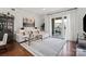 Bright living room with hardwood floors, neutral tones, and access to the balcony at 4625 Piedmont Row Dr # 712, Charlotte, NC 28210