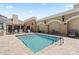 Refreshing community pool with clear blue water, comfortable seating, and a shallow water warning sign at 4625 Piedmont Row Dr # 712, Charlotte, NC 28210