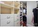 Walk-in closet featuring multiple shelves and built-in drawers at 4625 Piedmont Row Dr # 712, Charlotte, NC 28210