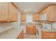 Functional kitchen featuring wood cabinets, granite countertops, and white appliances for a clean, updated look at 4937 Post Oak Ln, Rock Hill, SC 29732