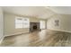 Bright living room with wood floors, a stone fireplace, vaulted ceilings and sliding glass doors to the backyard at 4937 Post Oak Ln, Rock Hill, SC 29732
