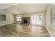 Bright living room with wood floors, a stone fireplace, vaulted ceilings and sliding glass doors to the backyard at 4937 Post Oak Ln, Rock Hill, SC 29732