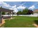 Backyard features a pergola-covered patio and large, well-maintained lawn at 5042 Alston Dr, Lancaster, SC 29720