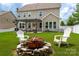A well-maintained backyard features a cozy fire pit and pergola with outdoor seating for relaxation and enjoyment at 5042 Alston Dr, Lancaster, SC 29720