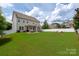 Expansive backyard features a well-manicured lawn, white fencing, and a cozy outdoor seating area with a pergola at 5042 Alston Dr, Lancaster, SC 29720