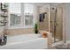 Bright bathroom featuring a soaking tub with a tile surround and a glass-enclosed shower at 5042 Alston Dr, Lancaster, SC 29720
