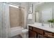 Bathroom featuring tub and shower with neutral tile and a vanity with dark wood cabinets at 5042 Alston Dr, Lancaster, SC 29720