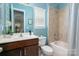 Well-lit bathroom with a combined tub and shower, light blue walls, and an elegant dark wood vanity at 5042 Alston Dr, Lancaster, SC 29720