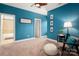 Well-lit bedroom with blue accent wall and carpet flooring at 5042 Alston Dr, Lancaster, SC 29720