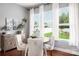 Sunlit dining area with wood table, seating for four, large windows with backyard views, and wood flooring at 5042 Alston Dr, Lancaster, SC 29720