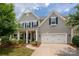 Charming two-story home featuring a two-car garage, inviting front porch and manicured landscaping for excellent curb appeal at 5042 Alston Dr, Lancaster, SC 29720