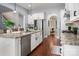 Well-lit kitchen with stainless steel appliances, white cabinetry, kitchen island, and an open floor plan at 5042 Alston Dr, Lancaster, SC 29720