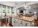 Open concept kitchen with granite countertops, stainless steel appliances, island and adjacent dining and living spaces at 5042 Alston Dr, Lancaster, SC 29720