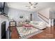 Living room with neutral tones, lots of seating, decorative fireplace, and hardwood floors at 5042 Alston Dr, Lancaster, SC 29720