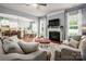 Open-concept living room with a decorative fireplace, hardwood floors and seamless flow into the kitchen and dining areas at 5042 Alston Dr, Lancaster, SC 29720