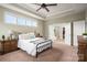 Spacious main bedroom with a tray ceiling, multiple windows, and an adjoining bathroom and walk-in closet at 5042 Alston Dr, Lancaster, SC 29720